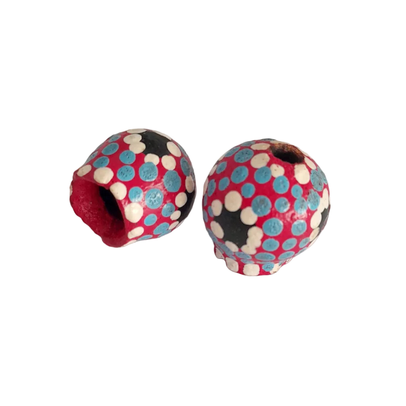 Two handmade wooden beads with a colorful polka dot pattern of pink, light blue, black, and white,