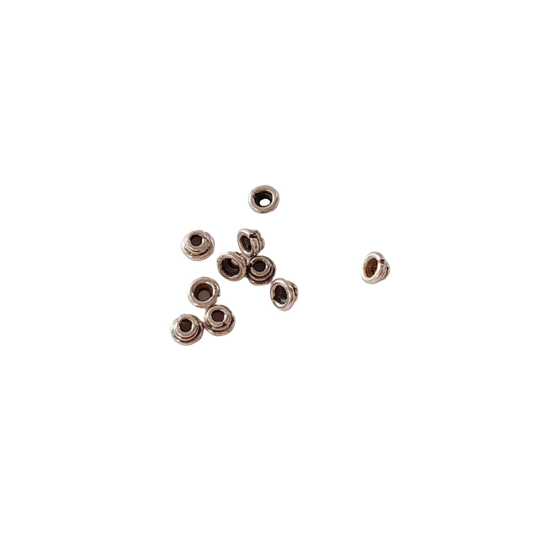Small metal beads on a light gray background