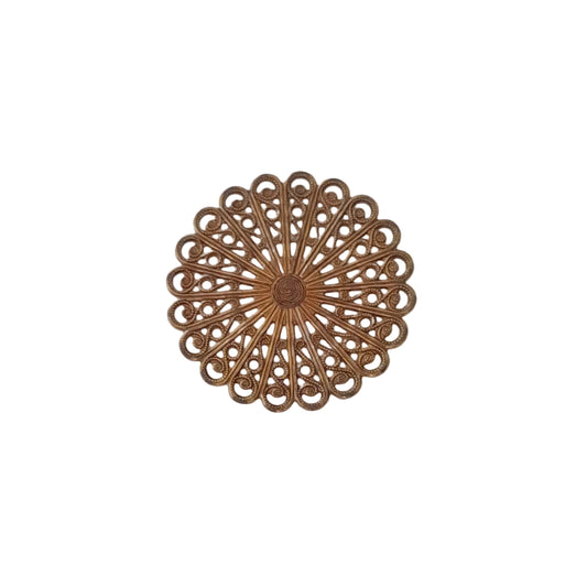 A round, ornate metal wall decor piece with a filigree sunburst design in a warm bronze finish, 
