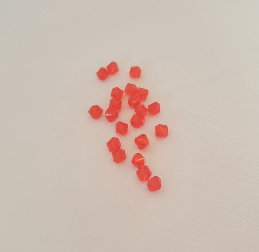 A small cluster of translucent red-orange faceted beads swarovski brand hyacinth 4mm