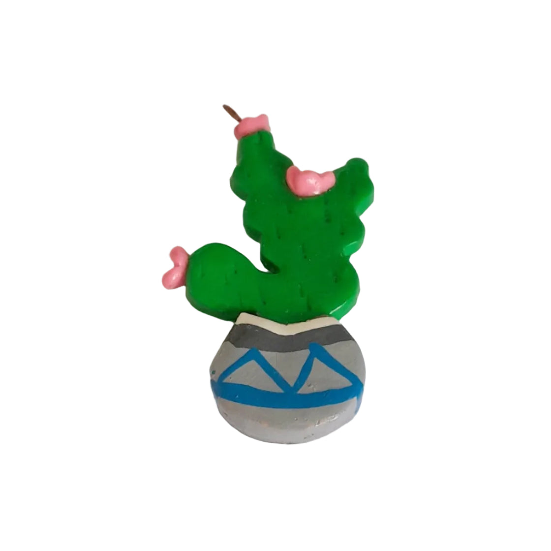 A small green cactus-shaped charm or candle topper with pink accents and a gray base decorated with blue and gray geometric patterns, 