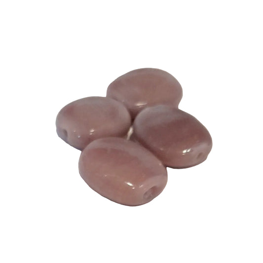 polished oval beads in a dusty mauve-pink colour, arranged on a plain off-white surface.