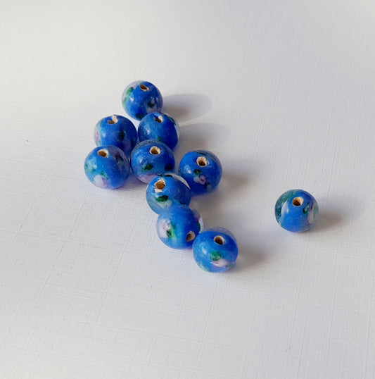 small 8mm round blue glass beads with colourful swirls of green, white, and purple, indian