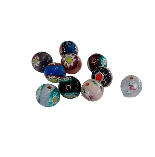 A group of ten colorful glass lampwork beads with various patterns, including floral, geometric, and swirl designs, from india 10mm round