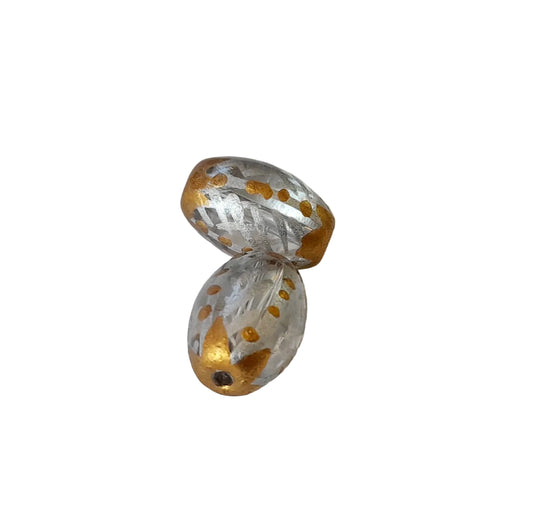handmade glass beads with a faceted, ribbed texture, featuring a silver-gray base decorated with gold metallic speckles and gold metallic bands, r