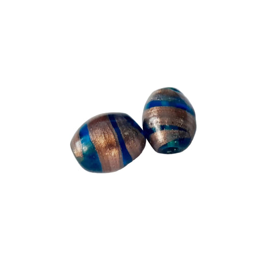 Two handmade glass beads with metallic copper and blue striped patterns, indian