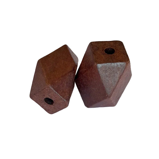 Two geometric, faceted metal beads with a rustic, rusted brown finish and pre-drilled holes, 