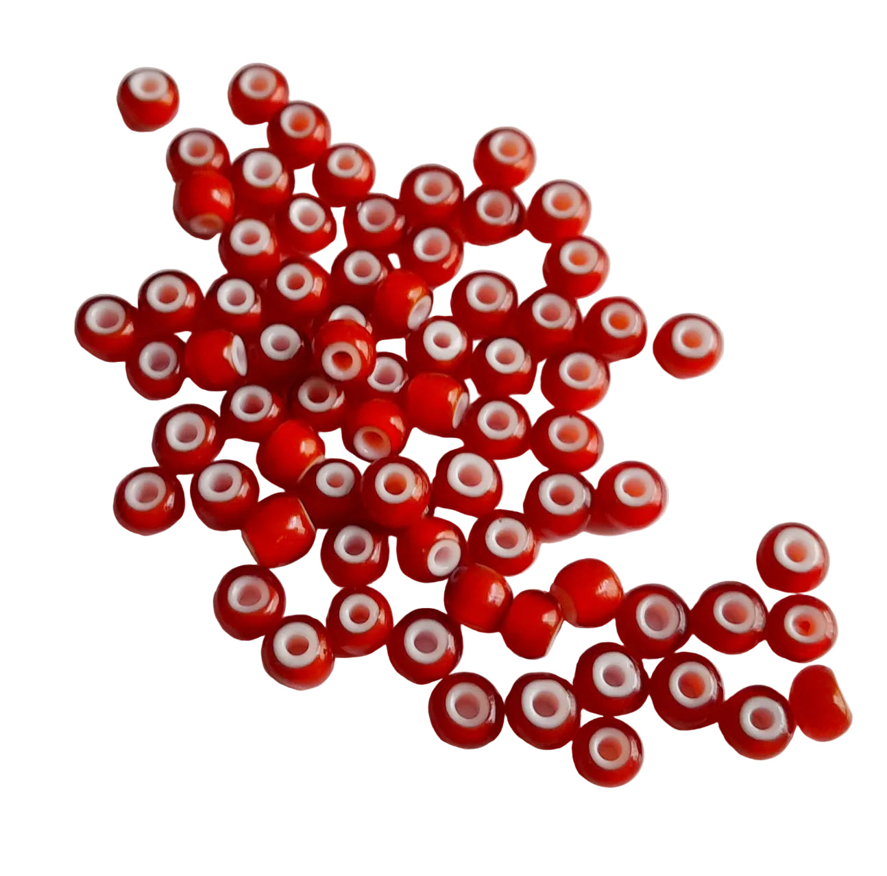 orange beads with white centers scattered on a light gray background