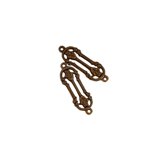 Two ornate antique bronze metal jewelry findings with decorative scrollwork and loops,