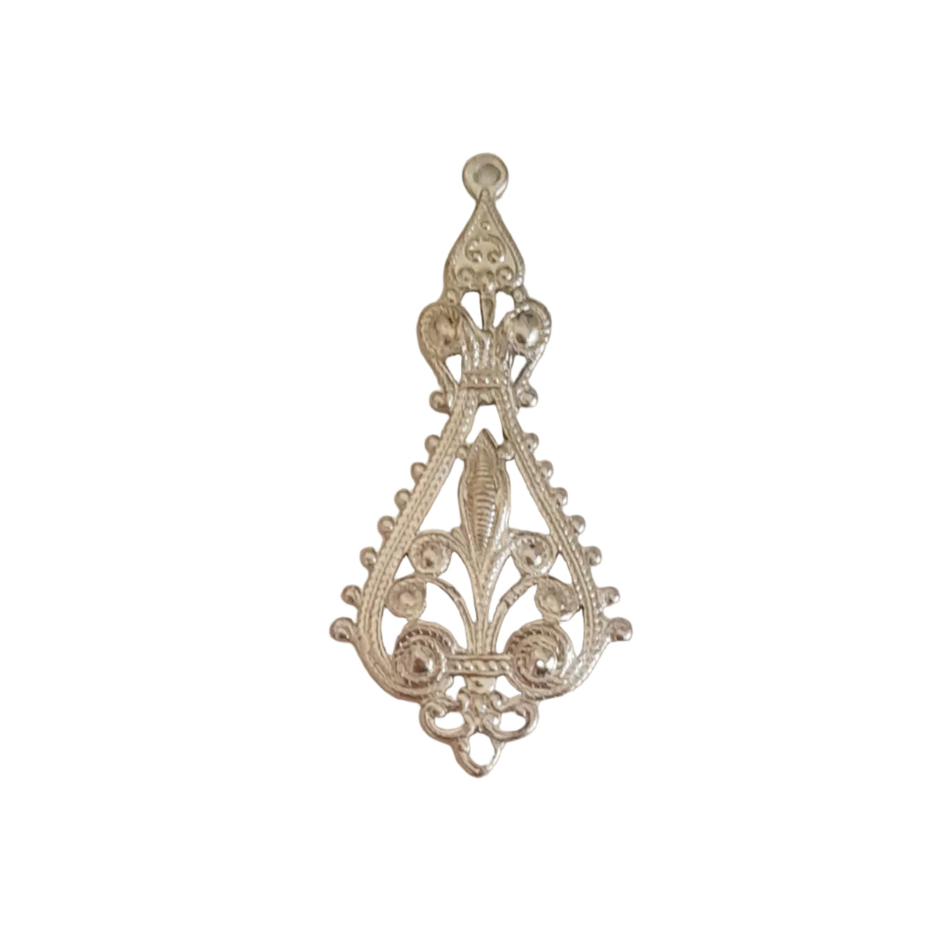 An ornate silver filigree pendant with a decorative teardrop shape and intricate scrollwork, 