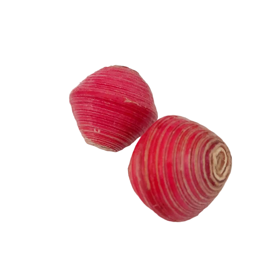 Two small, rounded, striped pink and white objects with a textured, ribbed surface, photographed on a plain off-white background.