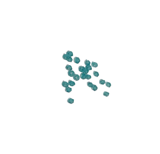 A small cluster of translucent teal blue swarovski beads indicolite 3mm bicone