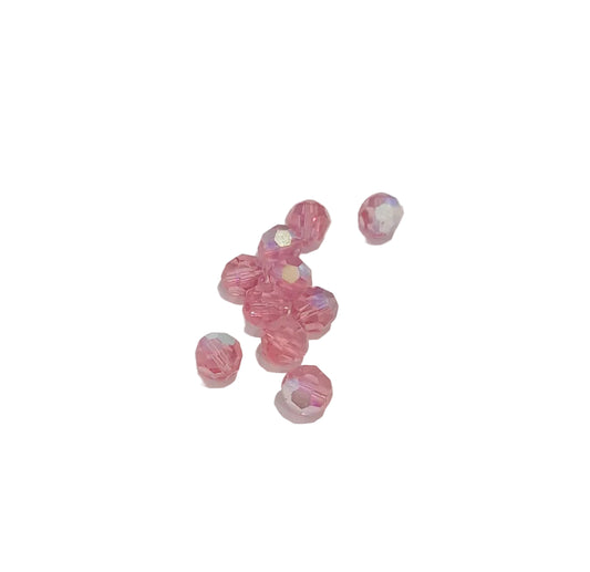 A group of 6mm round faceted pink glass crystal swarovski beads with an iridescent ab finish,