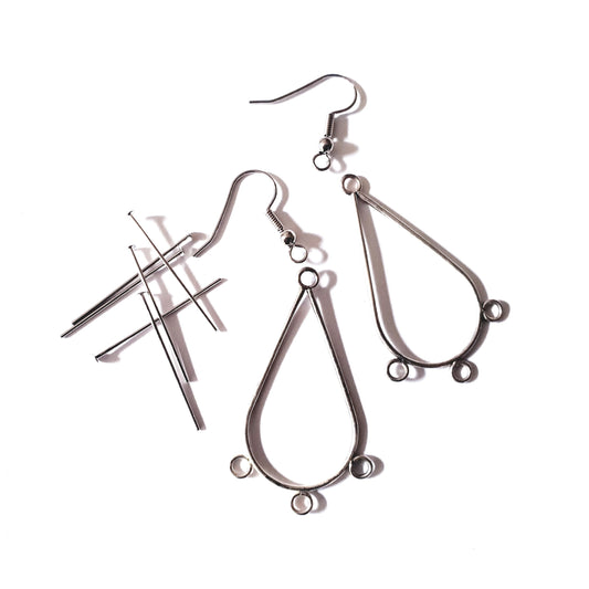 A kit containing earring frames, head pins, and fish hooks for jewelry making, displayed on a white background.