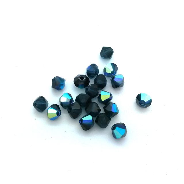 A collection of machine cut Czech Preciosa crystal bicone Montana AB beads in 4mm size with a blue color and multicolored reflective surface.